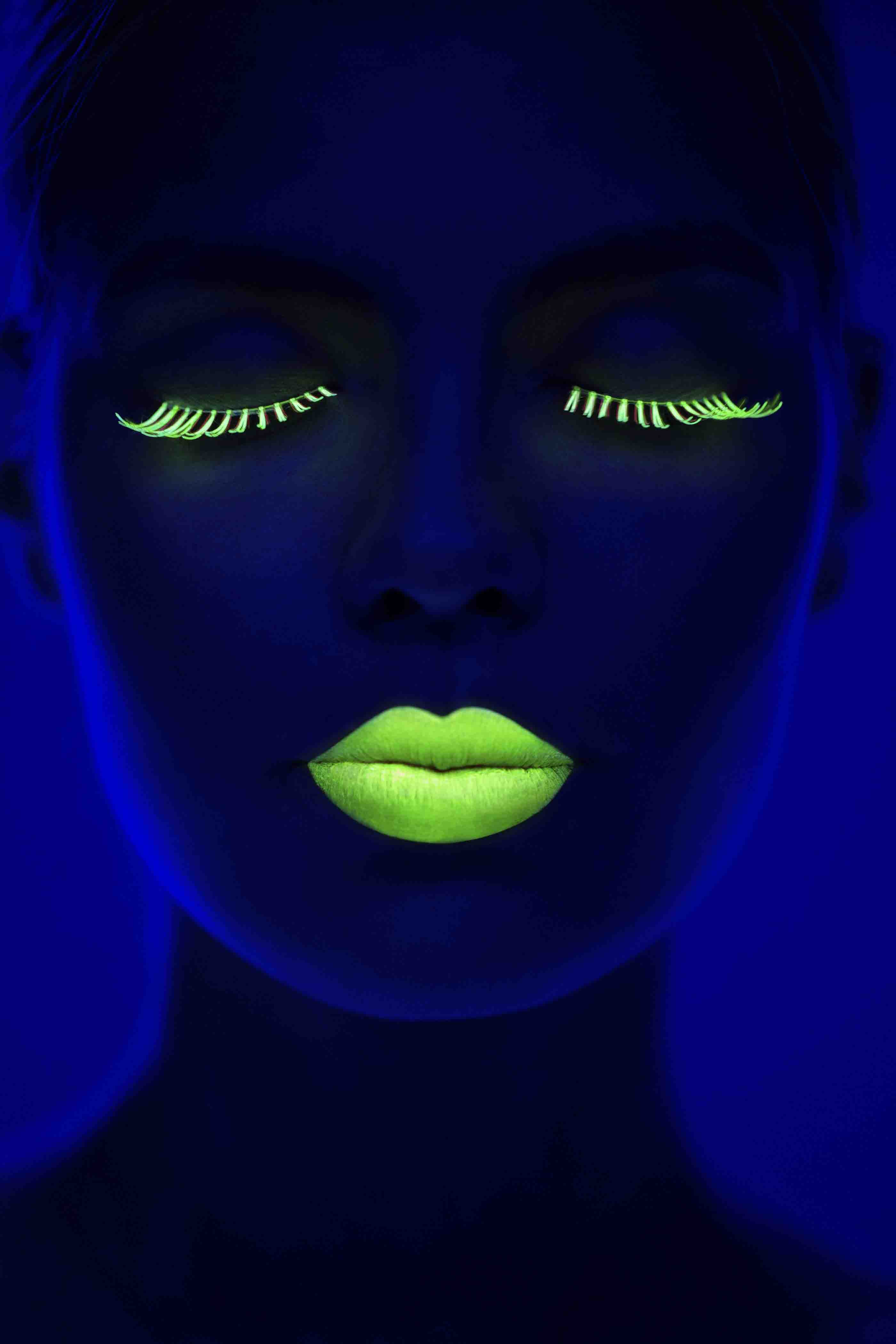 photograph of a woman illuminated with a neon light